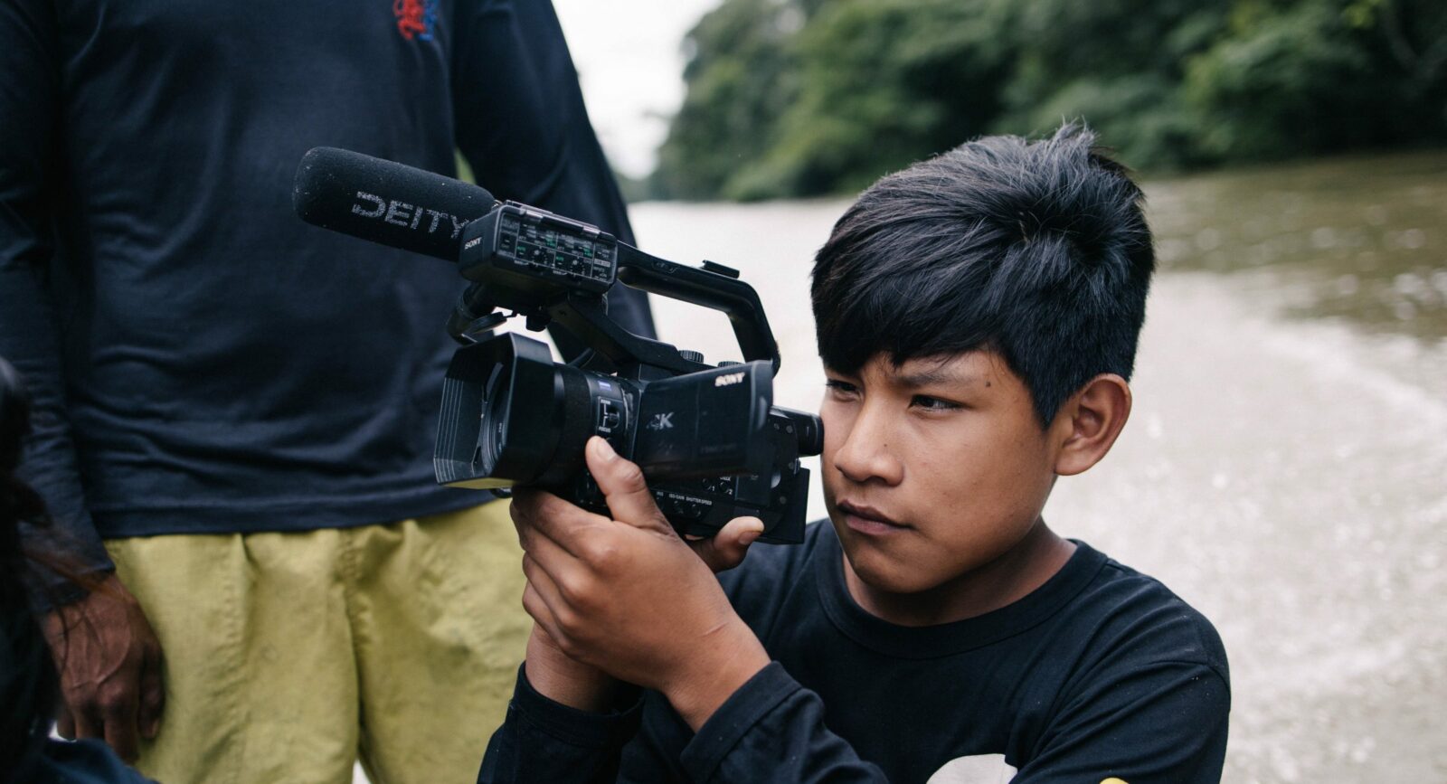 Young wru-eu-uau-uau boy taking footage on a digital camera.